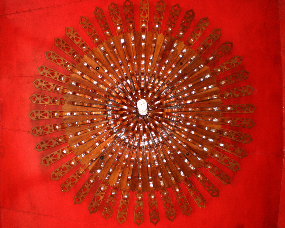 Wheel Around A Light, Against A Red Ceiling